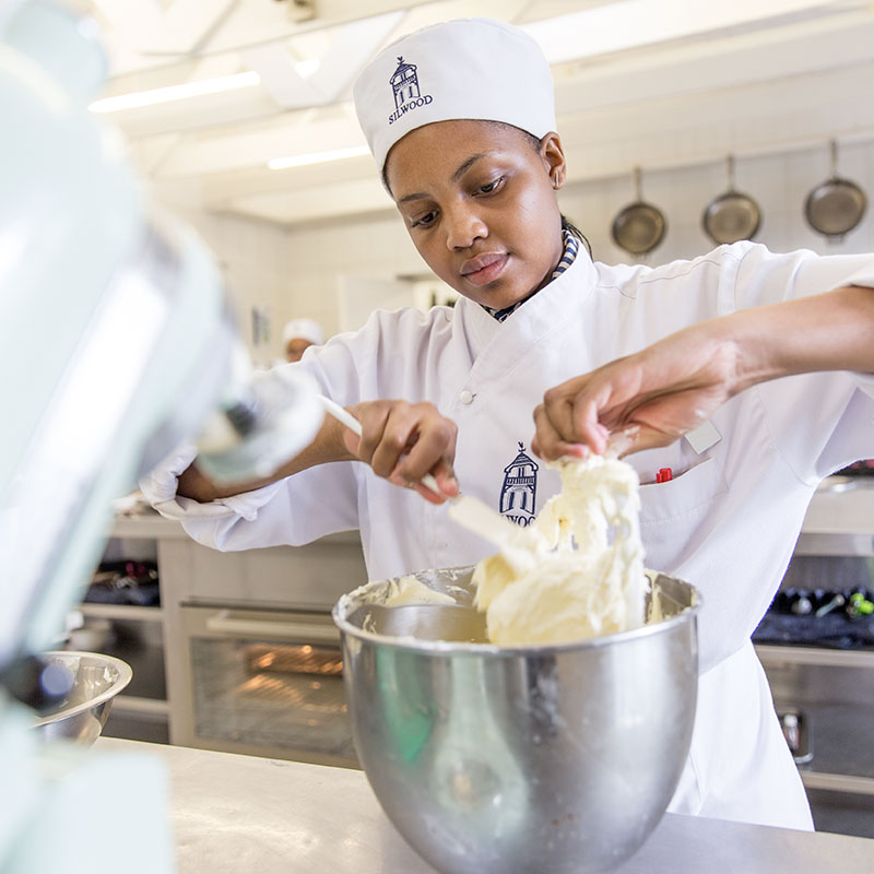 students cooking in kitchen at silwood school of cookery