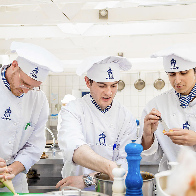 students cooking in kitchen at silwood school of cookery